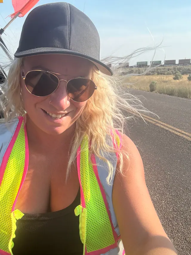J and L Pilots team member wearing a reflective vest beside the highway