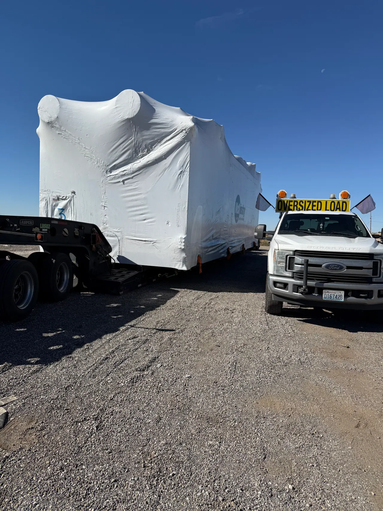 J and L Pilots escort truck equipped with an oversize load sign